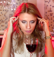 Image showing sad woman with glass of red wine