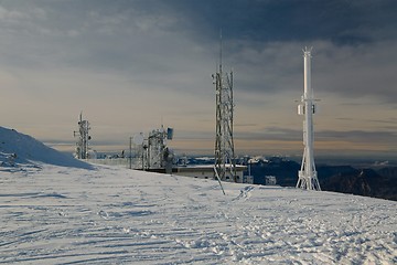 Image showing Transmitter towers on a hill in winter