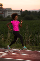 Image showing a young African American woman jogging outdoors