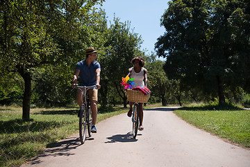 Image showing Young multiethnic couple having a bike ride in nature