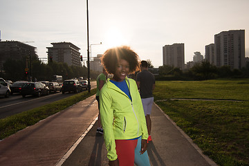 Image showing Portrait of sporty young african american woman running outdoors