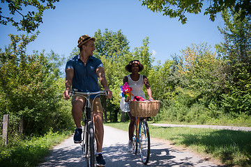 Image showing Young multiethnic couple having a bike ride in nature