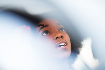 Image showing woman making makeup while driving car