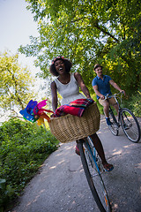 Image showing Young multiethnic couple having a bike ride in nature