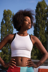 Image showing Portrait of sporty young african american woman running outdoors