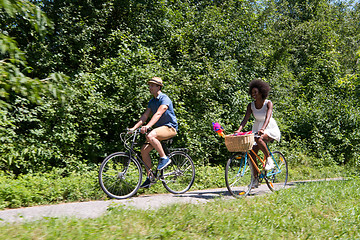 Image showing Young multiethnic couple having a bike ride in nature