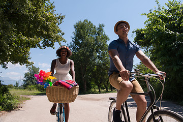 Image showing Young multiethnic couple having a bike ride in nature