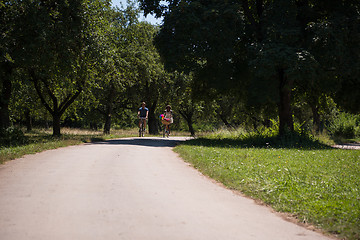 Image showing Young multiethnic couple having a bike ride in nature