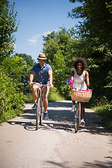 Image showing Young multiethnic couple having a bike ride in nature