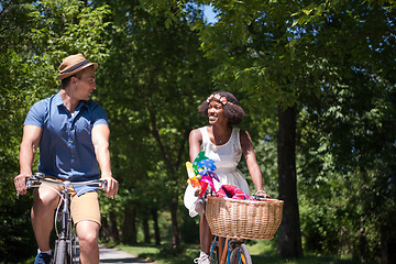 Image showing Young multiethnic couple having a bike ride in nature