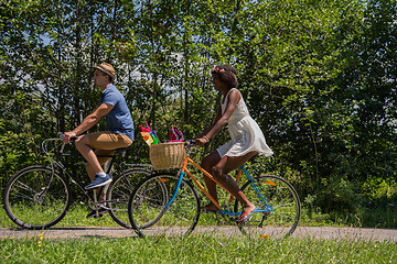 Image showing Young multiethnic couple having a bike ride in nature