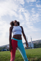 Image showing Portrait of sporty young african american woman running outdoors