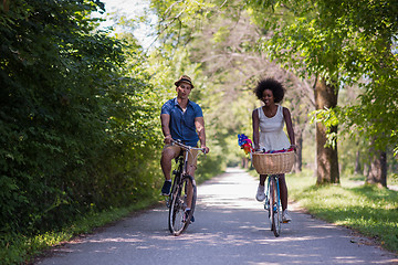 Image showing Young multiethnic couple having a bike ride in nature