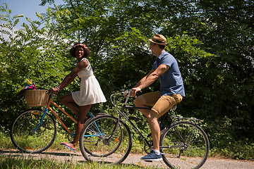 Image showing Young multiethnic couple having a bike ride in nature