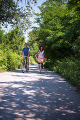 Image showing Young multiethnic couple having a bike ride in nature