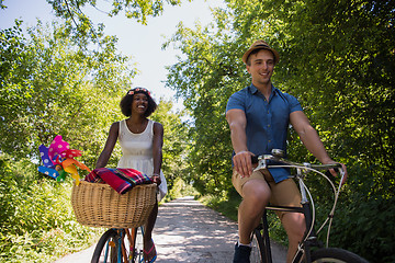 Image showing Young multiethnic couple having a bike ride in nature