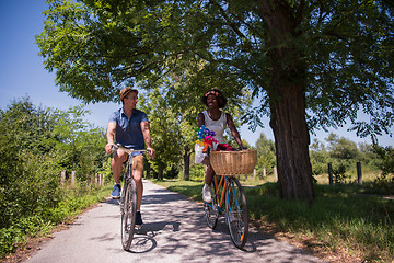 Image showing Young multiethnic couple having a bike ride in nature