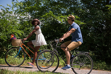 Image showing Young multiethnic couple having a bike ride in nature