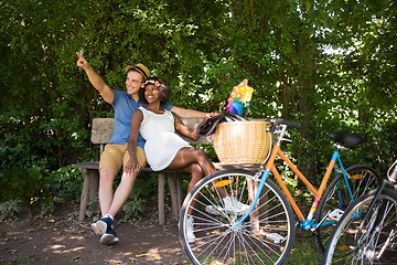 Image showing Young multiethnic couple having a bike ride in nature