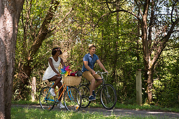 Image showing Young multiethnic couple having a bike ride in nature