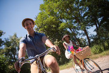 Image showing Young multiethnic couple having a bike ride in nature