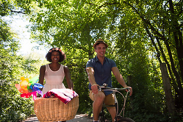 Image showing Young multiethnic couple having a bike ride in nature