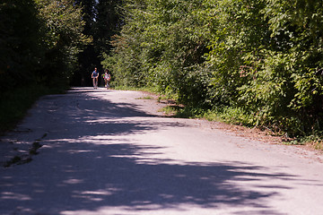 Image showing Young multiethnic couple having a bike ride in nature