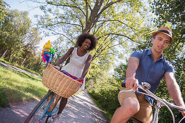 Image showing Young multiethnic couple having a bike ride in nature