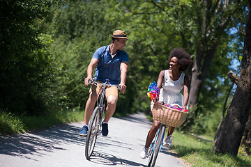 Image showing Young multiethnic couple having a bike ride in nature