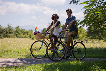 Image showing Young multiethnic couple having a bike ride in nature