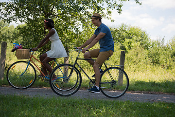 Image showing Young multiethnic couple having a bike ride in nature