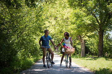 Image showing Young multiethnic couple having a bike ride in nature