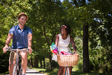 Image showing Young multiethnic couple having a bike ride in nature