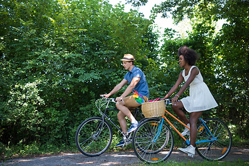 Image showing Young multiethnic couple having a bike ride in nature