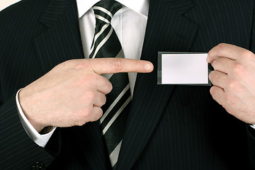 Image showing Salesman pointing to his nametag