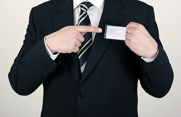 Image showing Salesman pointing out his nametag