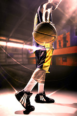 Image showing Silhouette view of a basketball player holding basket ball