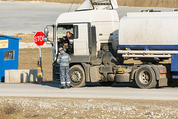 Image showing Taman, Russia - November 5, 2016: Verification of documents from the driver tank truck at security checkpoint at vezde the protected area