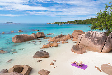 Image showing Woman sunbathing at Anse Lazio picture perfect beach on Praslin Island, Seychelles.