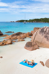 Image showing Woman sunbathing at Anse Lazio picture perfect beach on Praslin Island, Seychelles.