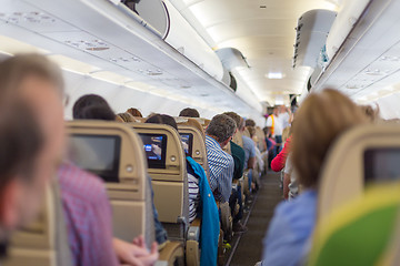 Image showing Interior of airplane with passengers on seats waiting to taik off.