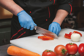 Image showing Chef cutting vegetables