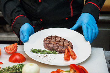 Image showing Chef set grilled meat