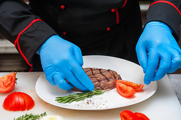 Image showing Chef set grilled meat