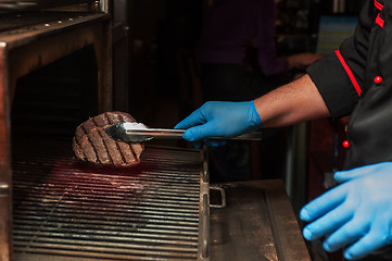 Image showing Chef roasts meat steak