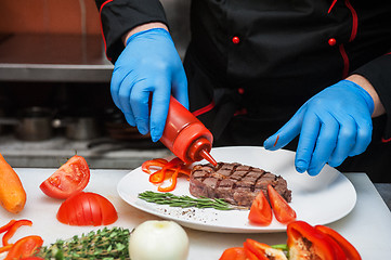 Image showing Chef set grilled meat