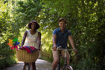 Image showing Young multiethnic couple having a bike ride in nature