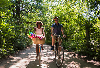 Image showing Young multiethnic couple having a bike ride in nature