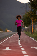 Image showing a young African American woman jogging outdoors