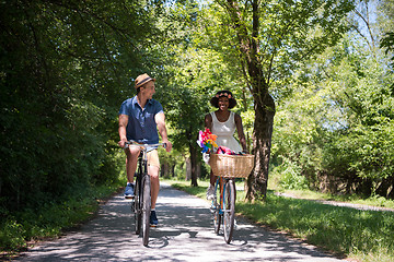 Image showing Young multiethnic couple having a bike ride in nature